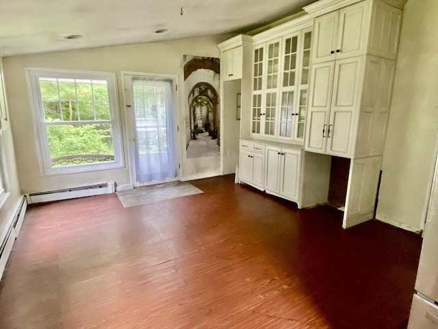 387 W Washington St, Hanson, MA 02341 - empty room featuring lofted ceiling, dark wood-type flooring, and a baseboard heating unit