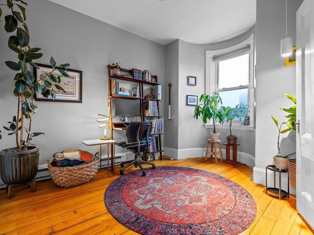 office with hardwood / wood-style floors and baseboards