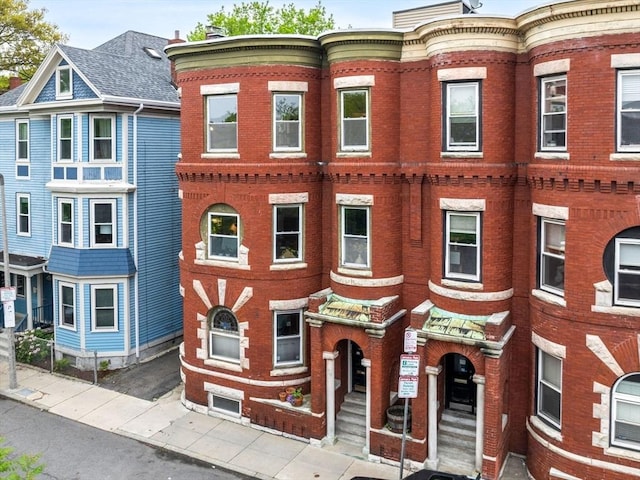 view of property featuring brick siding
