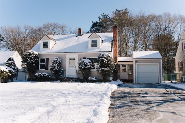 cape cod home with a garage