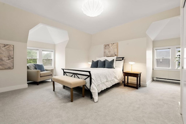 carpeted bedroom featuring a baseboard heating unit, baseboards, and vaulted ceiling