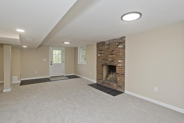 unfurnished living room with carpet floors, baseboards, and a fireplace