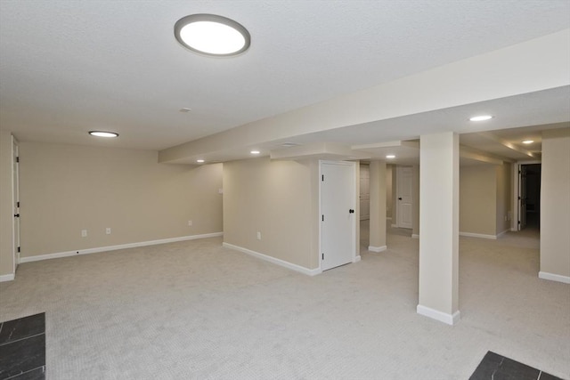 finished below grade area with light colored carpet, recessed lighting, and baseboards
