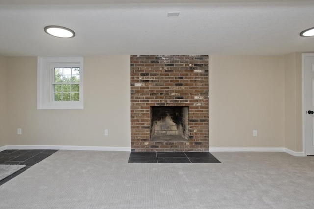 unfurnished living room featuring carpet floors, baseboards, and a brick fireplace