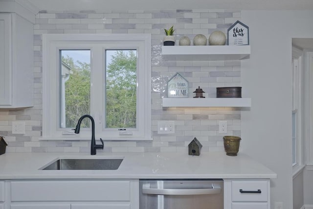 kitchen with stainless steel dishwasher, white cabinets, tasteful backsplash, open shelves, and light countertops