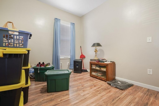 game room featuring wood finished floors and baseboards