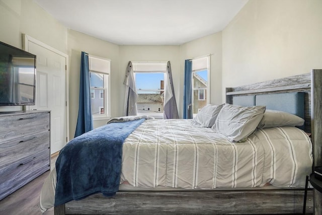 bedroom with dark wood-type flooring