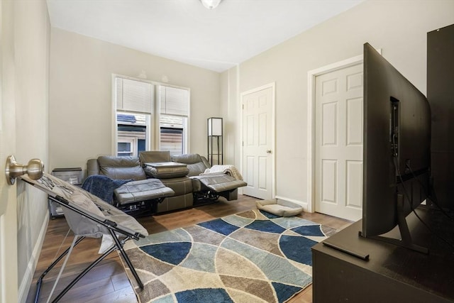 sitting room featuring baseboards and wood finished floors