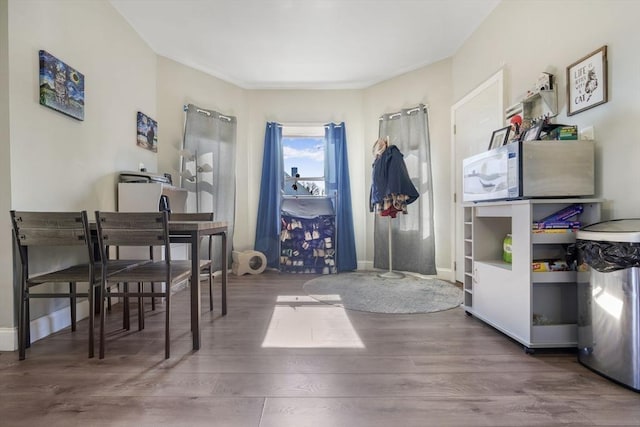 interior space with baseboards and wood finished floors