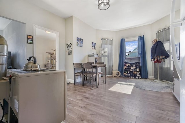 interior space featuring light wood-style floors and baseboards