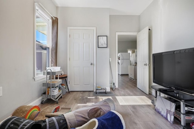 living room featuring light wood-style flooring and baseboards