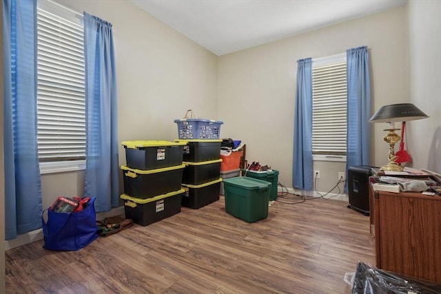 recreation room with dark wood-type flooring and baseboards