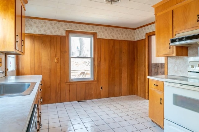 kitchen with under cabinet range hood, a sink, electric stove, light countertops, and wallpapered walls