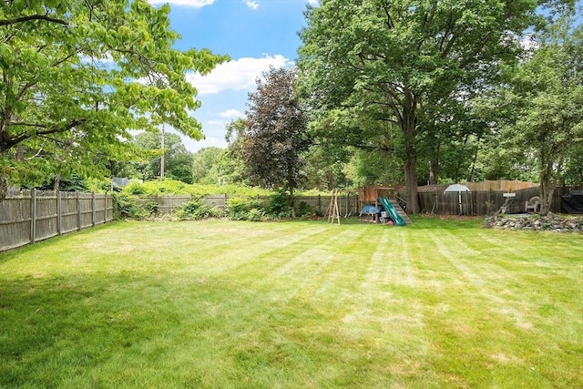 381 Water, Wakefield, MA 01880 - fenced backyard featuring a playground