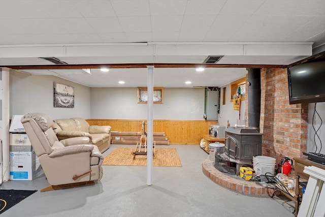 381 Water, Wakefield, MA 01880 - living area featuring finished concrete floors, wainscoting, a wood stove, and wood walls