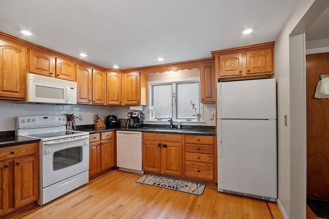 381 Water, Wakefield, MA 01880 - kitchen featuring white appliances, brown cabinetry, light wood-style flooring, decorative backsplash, and dark countertops