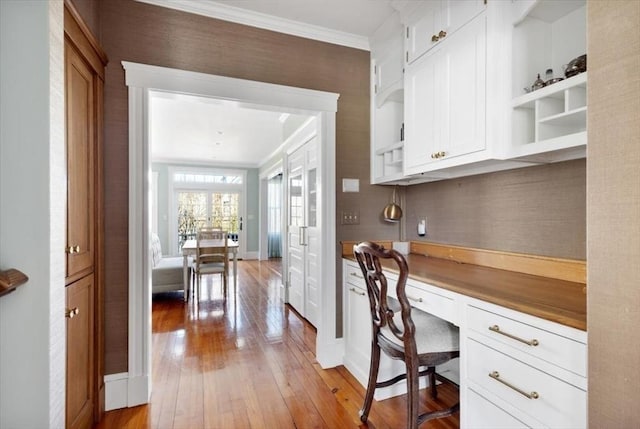 11 Paige St, Hingham, MA 02043 - office space with built in study area, light wood finished floors, crown molding, and baseboards