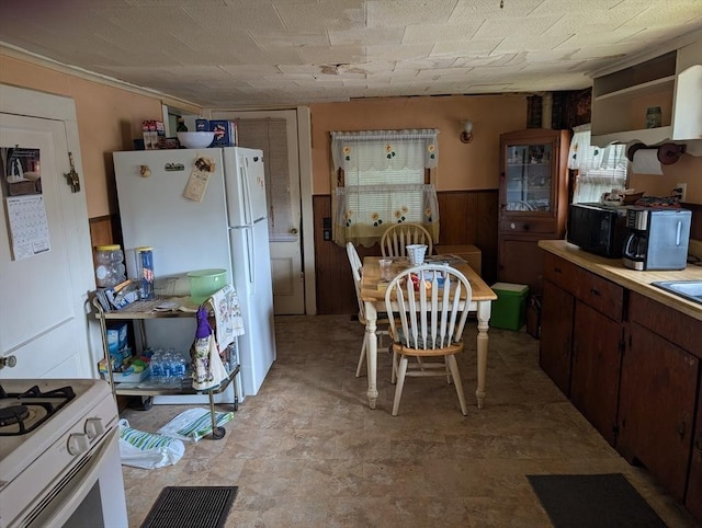 8 May St, Webster, MA 01570 - kitchen with white appliances, light countertops, wooden walls, wainscoting, and light floors