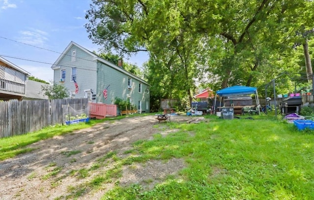 view of yard featuring fence and an outdoor fire pit