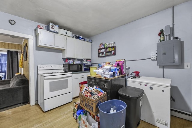 kitchen featuring white electric range oven, a baseboard heating unit, black microwave, electric panel, and fridge