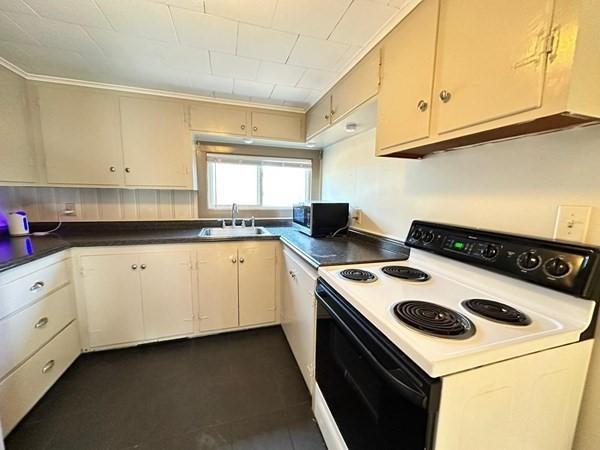 91 W Main St, West Brookfield, MA 01585 - kitchen featuring a sink, stainless steel microwave, electric range, dark countertops, and white dishwasher