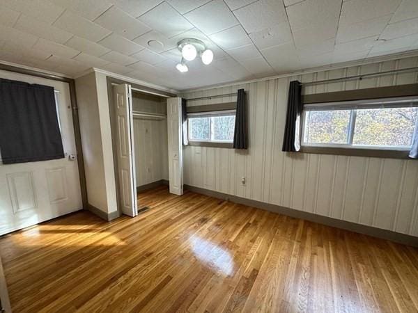 91 W Main St, West Brookfield, MA 01585 - unfurnished bedroom featuring light wood-type flooring, a closet, baseboards, and ornamental molding