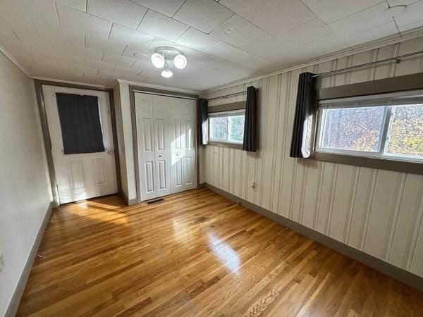91 W Main St, West Brookfield, MA 01585 - unfurnished bedroom with light wood finished floors, baseboards, and crown molding