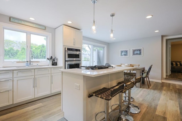 5 Birch Hill Rd, Dennis, MA 02639 - kitchen featuring a sink, appliances with stainless steel finishes, a kitchen bar, light wood-type flooring, and recessed lighting
