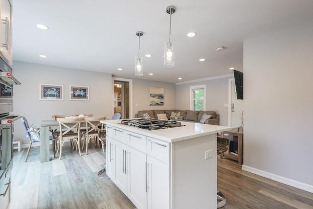 5 Birch Hill Rd, Dennis, MA 02639 - kitchen featuring stainless steel gas cooktop, white cabinets, a kitchen island, light wood-type flooring, and recessed lighting