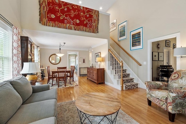 living room with light wood-type flooring, stairway, crown molding, recessed lighting, and baseboards