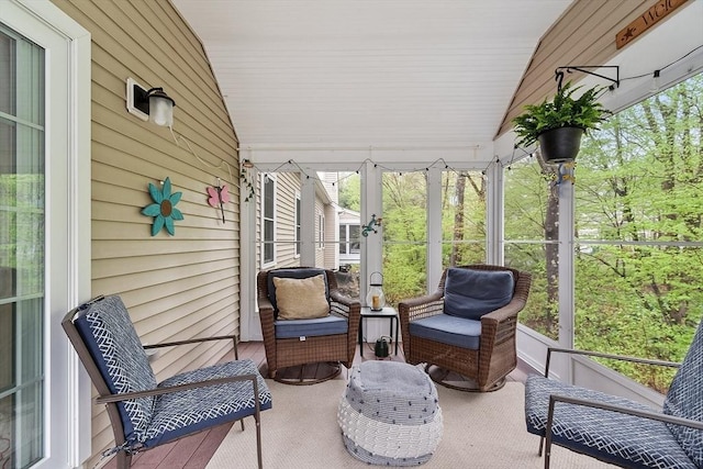 sunroom / solarium featuring lofted ceiling