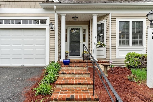 entrance to property featuring roof with shingles