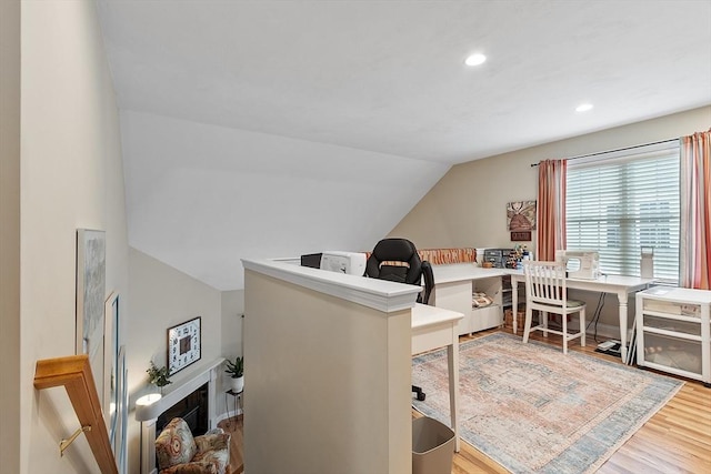 office with wood finished floors, lofted ceiling, and recessed lighting