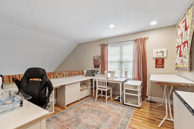office space featuring light wood finished floors, lofted ceiling, recessed lighting, and baseboards