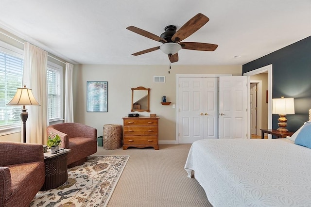 bedroom with light carpet, a ceiling fan, a closet, and baseboards