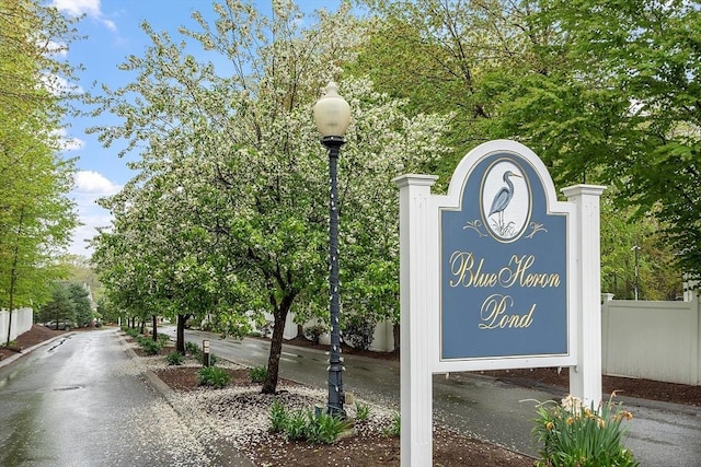 community / neighborhood sign with fence