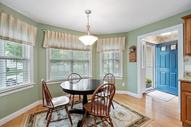 dining room featuring light wood-style floors and baseboards