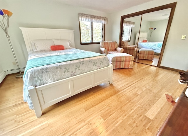 bedroom with a closet and light hardwood / wood-style flooring