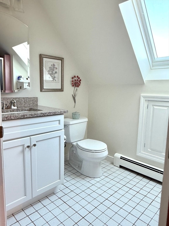 bathroom featuring a baseboard radiator, vanity, tile patterned floors, and lofted ceiling with skylight