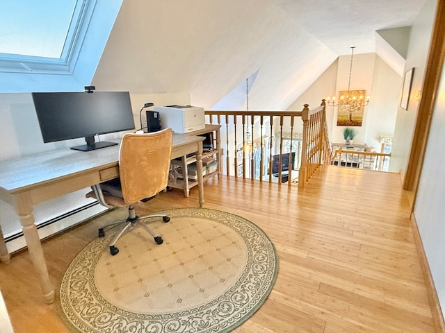 office space featuring hardwood / wood-style flooring, a baseboard radiator, lofted ceiling, and a notable chandelier