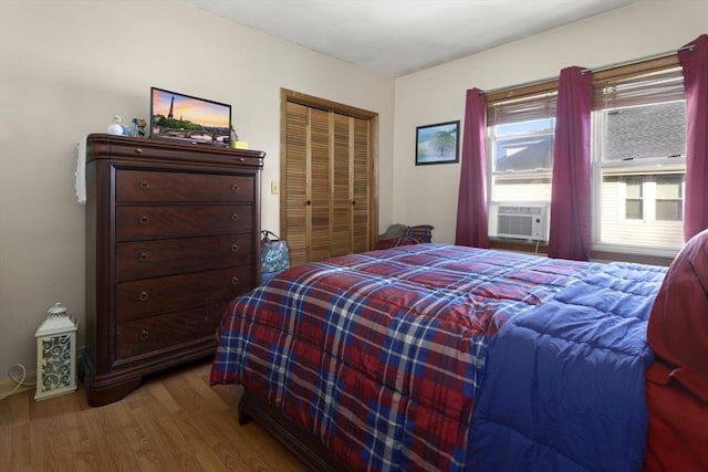 bedroom featuring a closet, cooling unit, and hardwood / wood-style floors