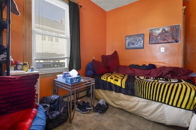 bedroom featuring a baseboard heating unit