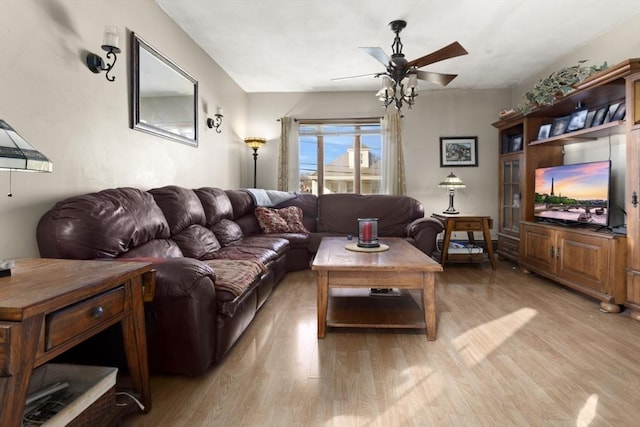 living room featuring light wood-type flooring and ceiling fan