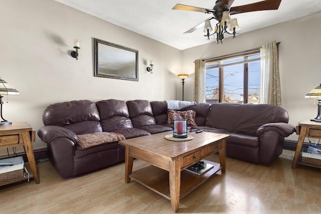 living room with ceiling fan and hardwood / wood-style floors