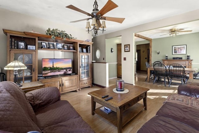 living room featuring ceiling fan and light wood-type flooring