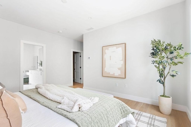 354 Linwood Ave Unit 354, Newton, MA 02460 - bedroom featuring light wood-style flooring, baseboards, and ensuite bath