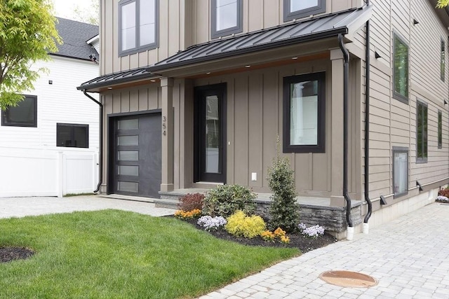 354 Linwood Ave Unit 354, Newton, MA 02460 - view of exterior entry with a standing seam roof, board and batten siding, metal roof, and a lawn