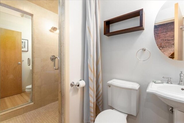 full bath featuring toilet and a shower stall
