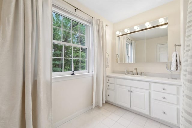 176 Crescent St, Stow, MA 01775 - bathroom with plenty of natural light, vanity, tile patterned flooring, and baseboards