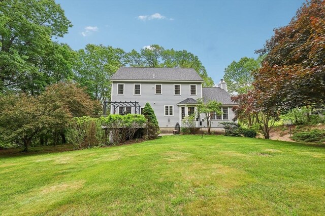 176 Crescent St, Stow, MA 01775 - back of property with a pergola, a chimney, and a lawn